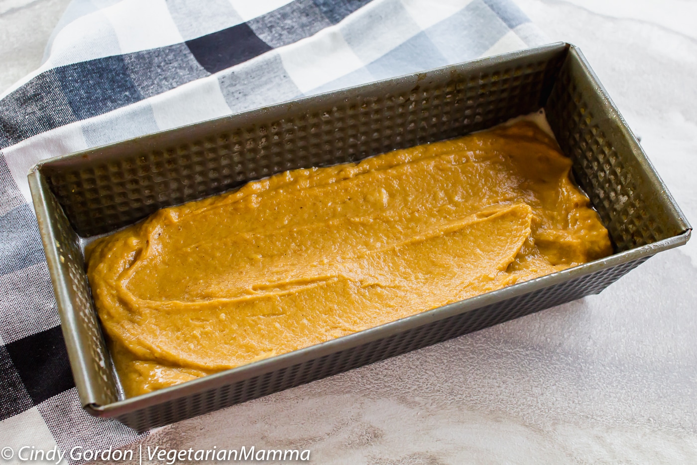 Metal bread pan with Gluten Free Pumpkin Bread batter