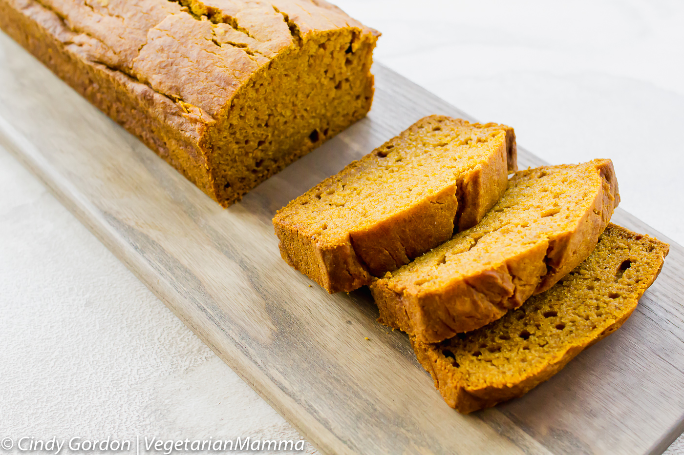 Gluten Free Pumpkin Bread sliced on a cutting board