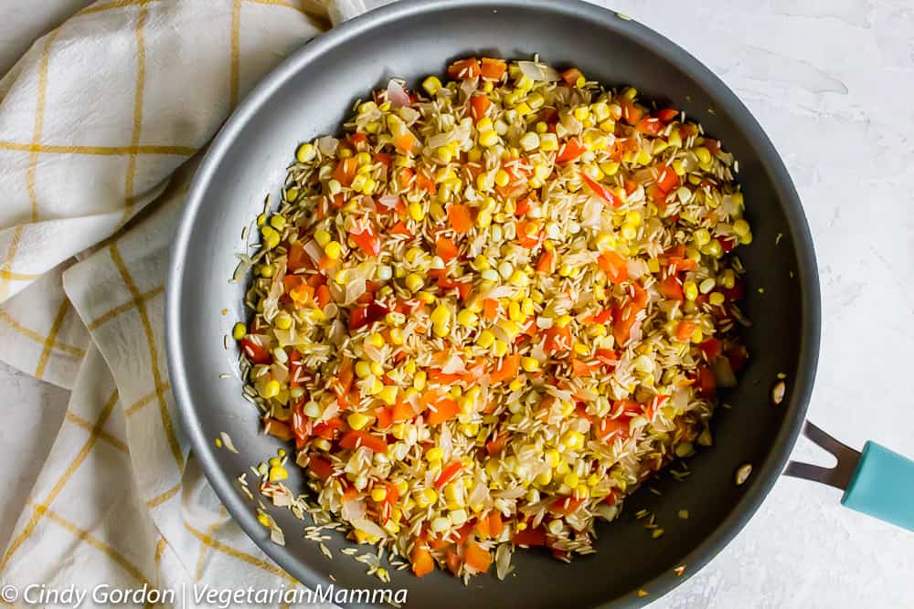 rice, peppers, and corn in a skillet