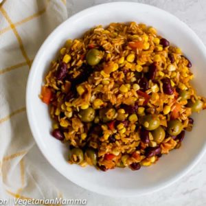 A delicious bowl of spanish rice with olives.