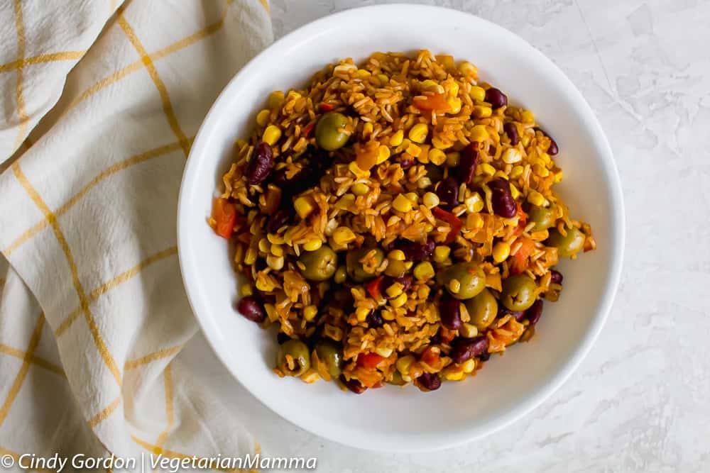 A delicious bowl of spanish rice with olives.