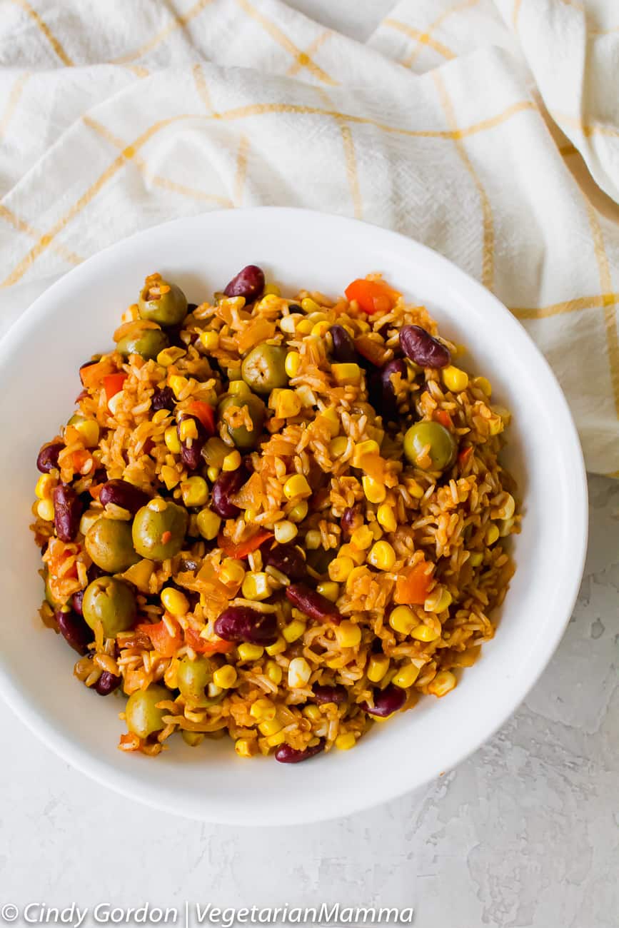 Spanish Rice with olives served in a white bowl