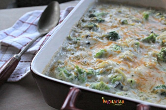 Gluten free Cheesy Broccoli Casserole dish with a spoon next to it.