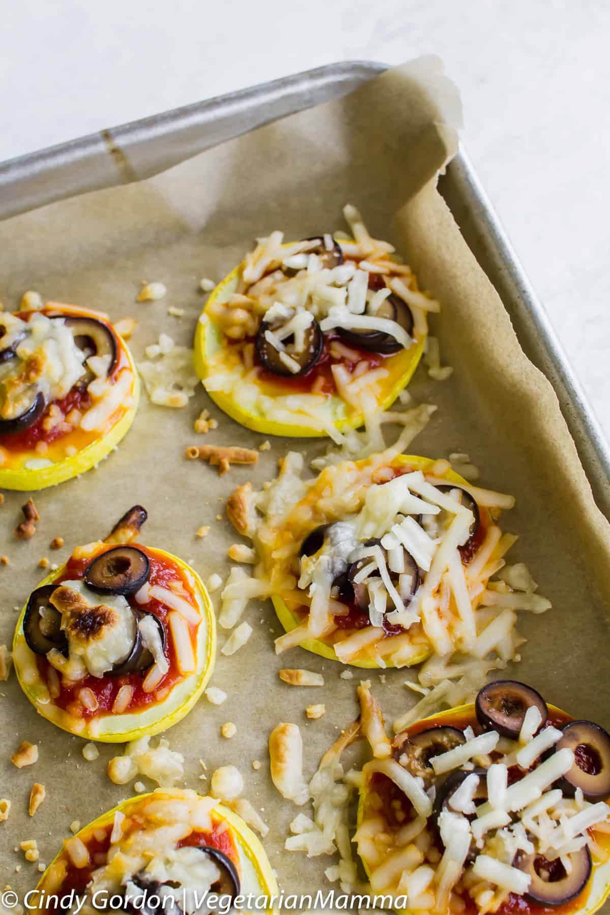 Zucchini Pizzas in metal pan atop white table