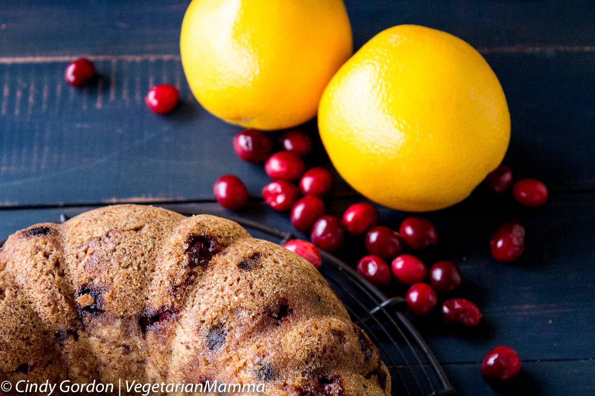 two oranges, cranberries and Gluten Free Cranberry Orange Cake 