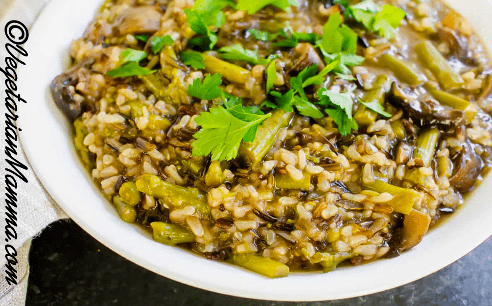 Mushroom and Asparagus Wild Rice in white bowl topped with fresh cilantro