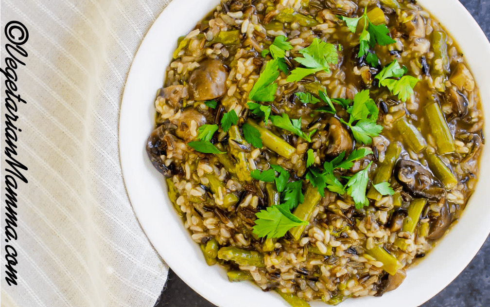 Mushroom and Asparagus Wild Rice served in white bowl atop black counter