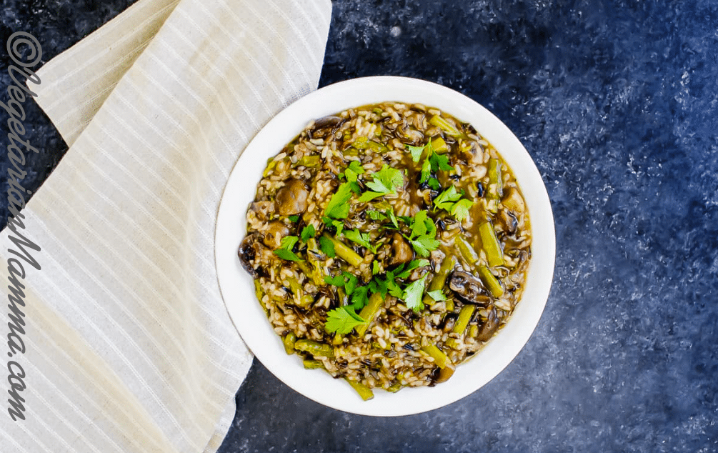 Top down view of Mushroom and Asparagus Wild Rice served in white bowl