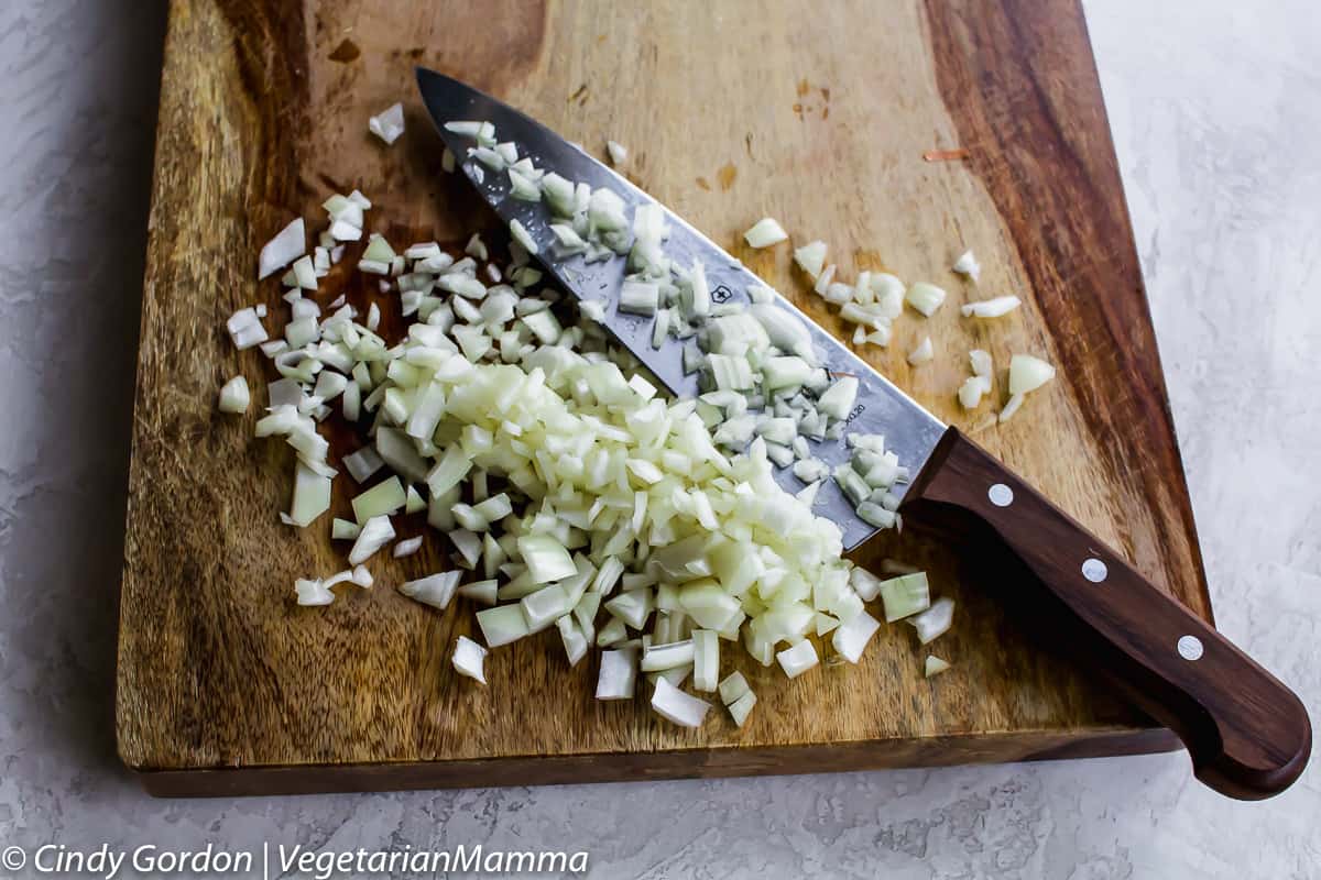 diced onions on a cutting board with a knife