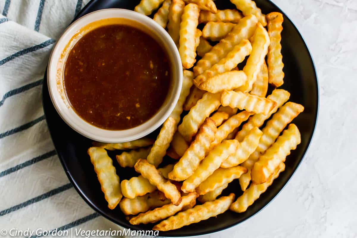 bowl of Dr Pepper BBQ Sauce on a plate with french fries