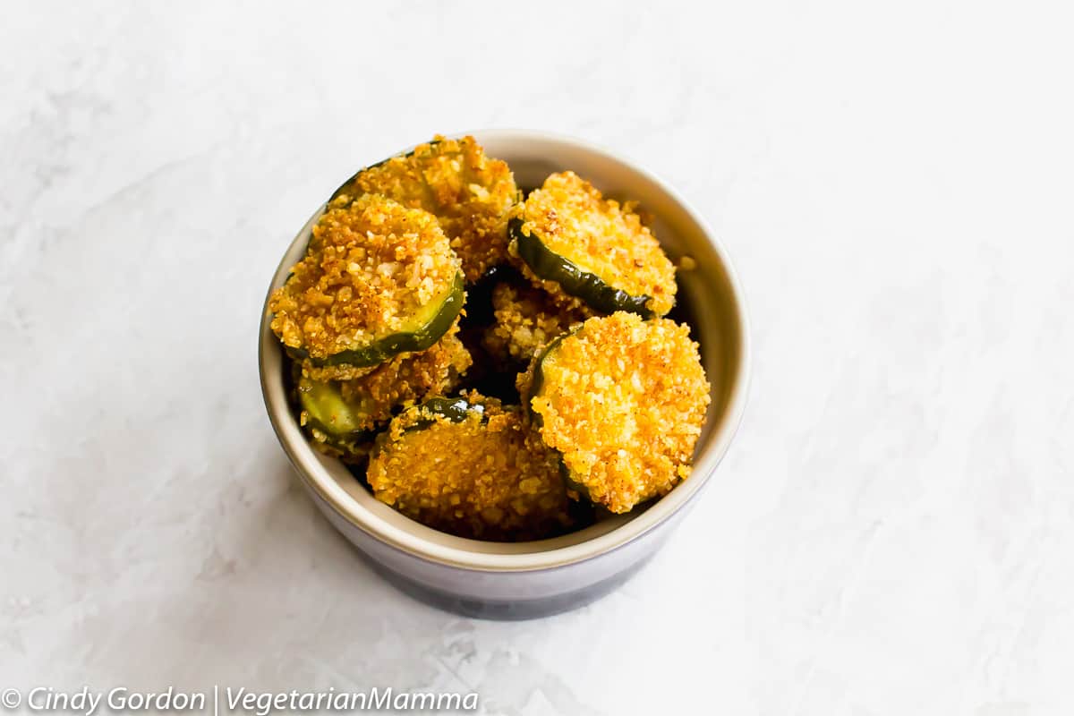 Gluten Free Fried Pickles in a ceramic bowl on a marble counter.