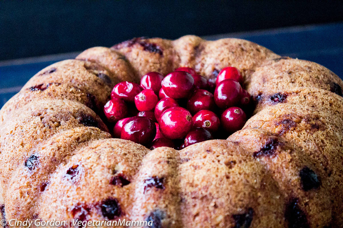 Gluten Free Cranberry Orange Bundt Cake topped with fresh cranberries