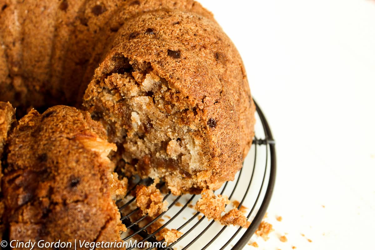 an unfrosted apple bundt cake on a wire rack, made with gluten free flour. 