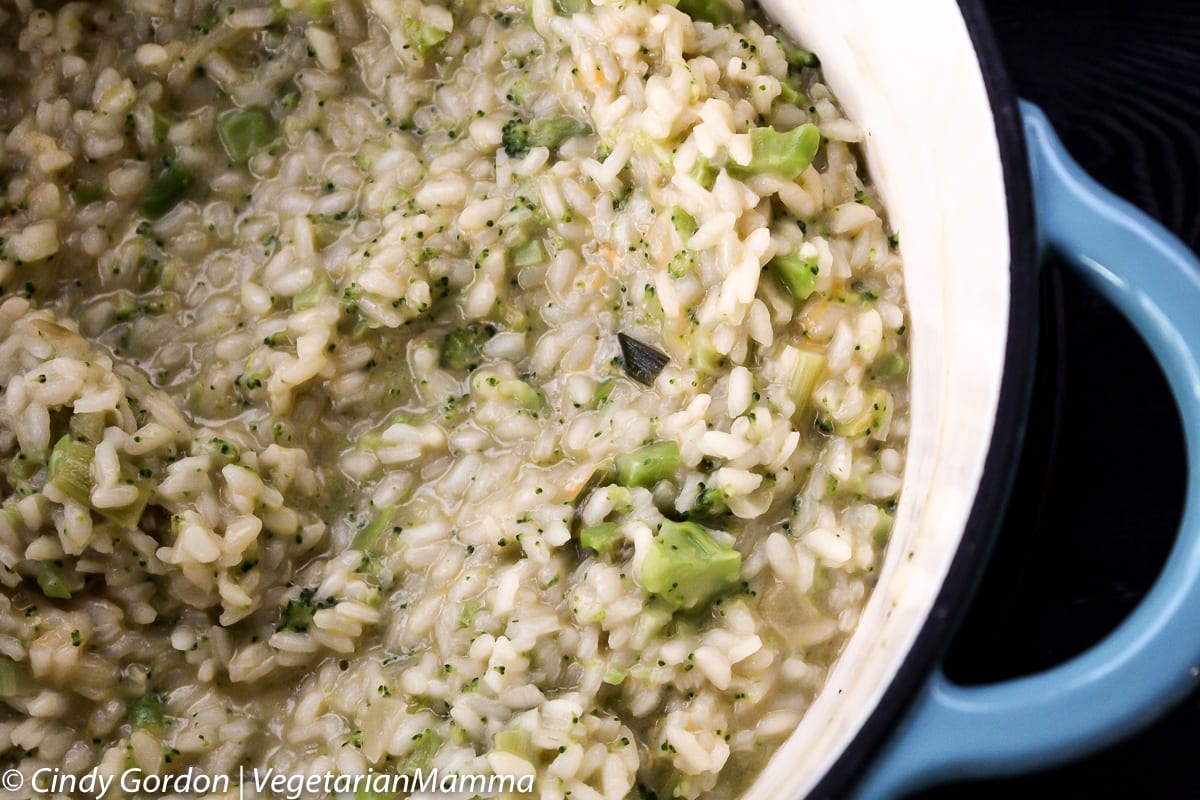 Broccoli and cheese risotto in a blue pot.