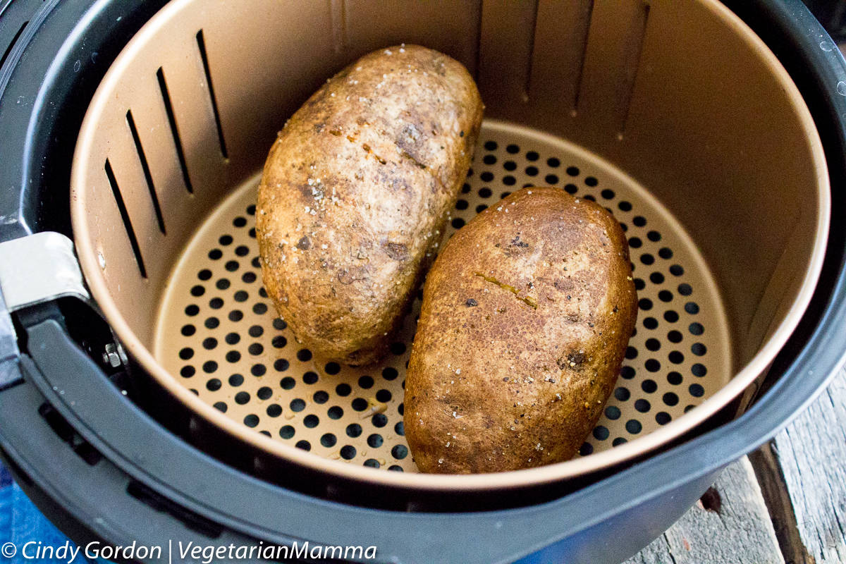 two whole baking potatoes in an air fryer