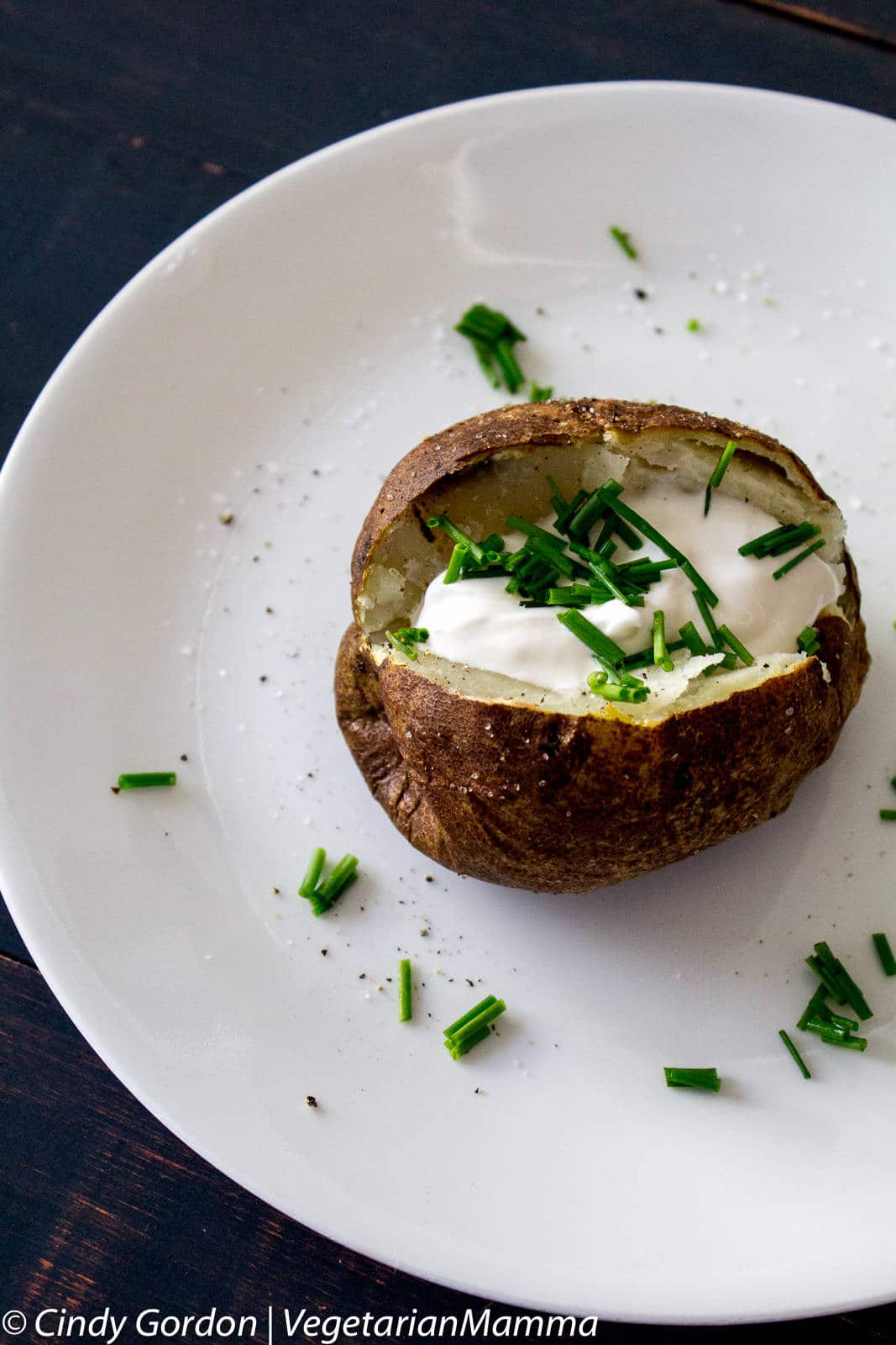 Air Fryer Baked Potato topped with sour cream and chives