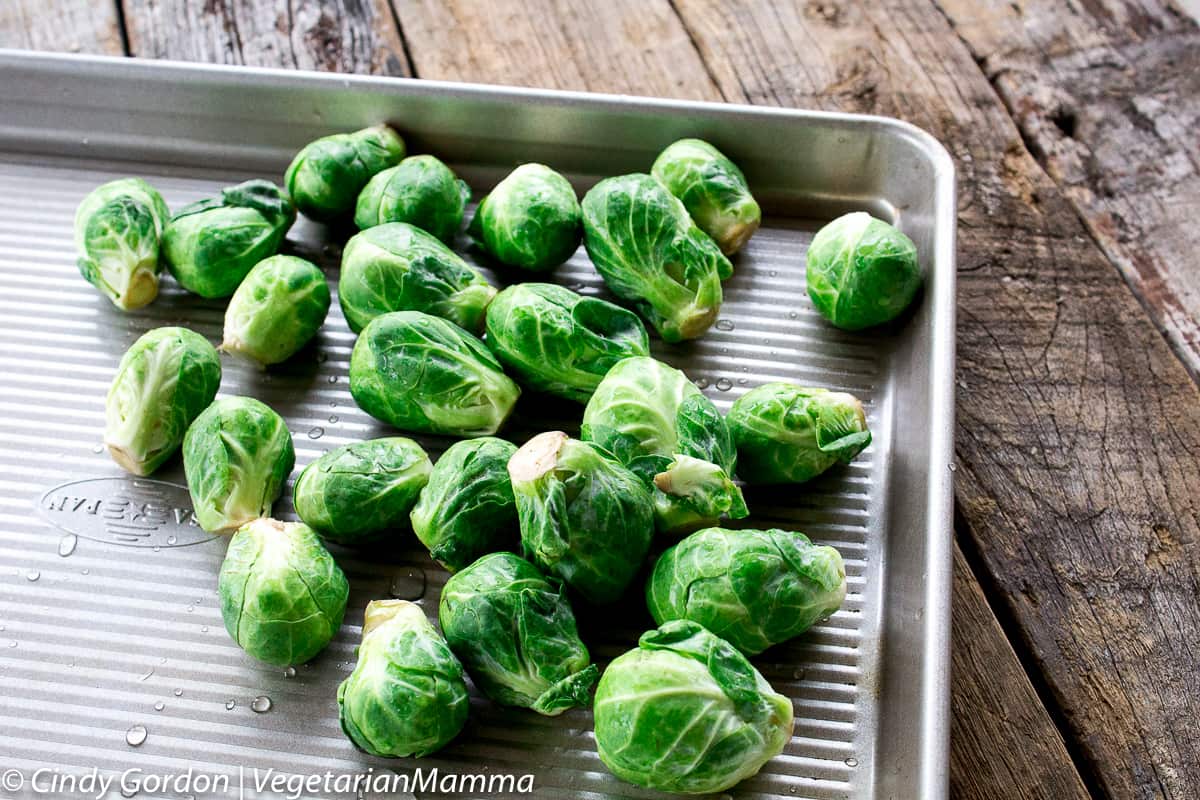 uncooked brussel sprouts on a baking sheet