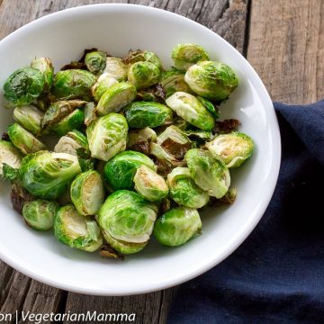 Air Fryer Brussel Sprouts served in white bowl with black cloth to the right