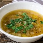 Instant Pot Potato Leek Soup in white bowl atop wooden pallet