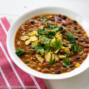 Instant Pot Taco Soup in white bowl followed by red and white striped cloth