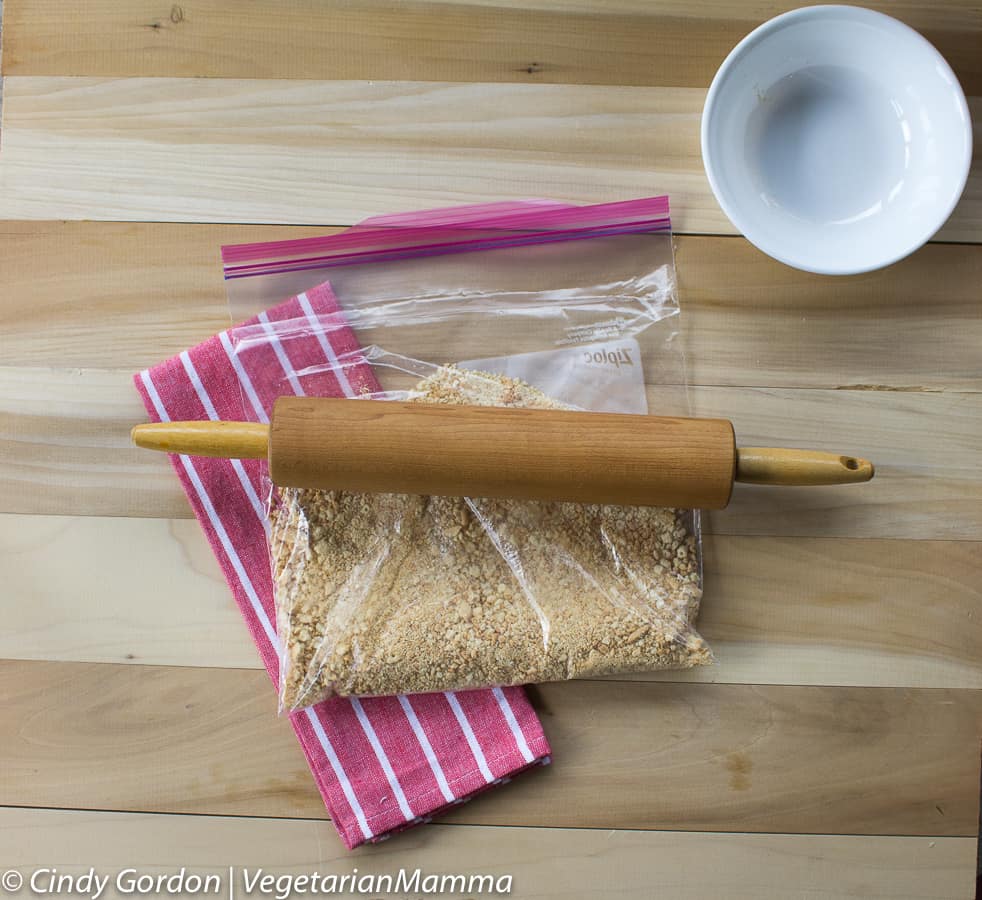 Crushing up gluten-free crackers in a resealable plastic bag. 