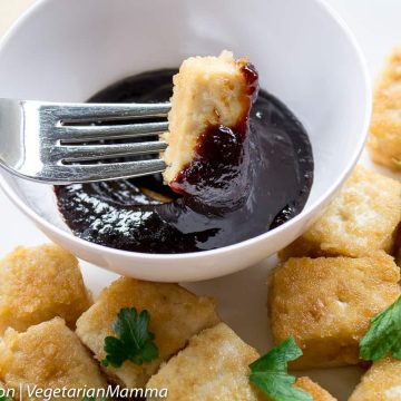 Kid Friendly Tofu Bites on plate with bite being dipped in sauce