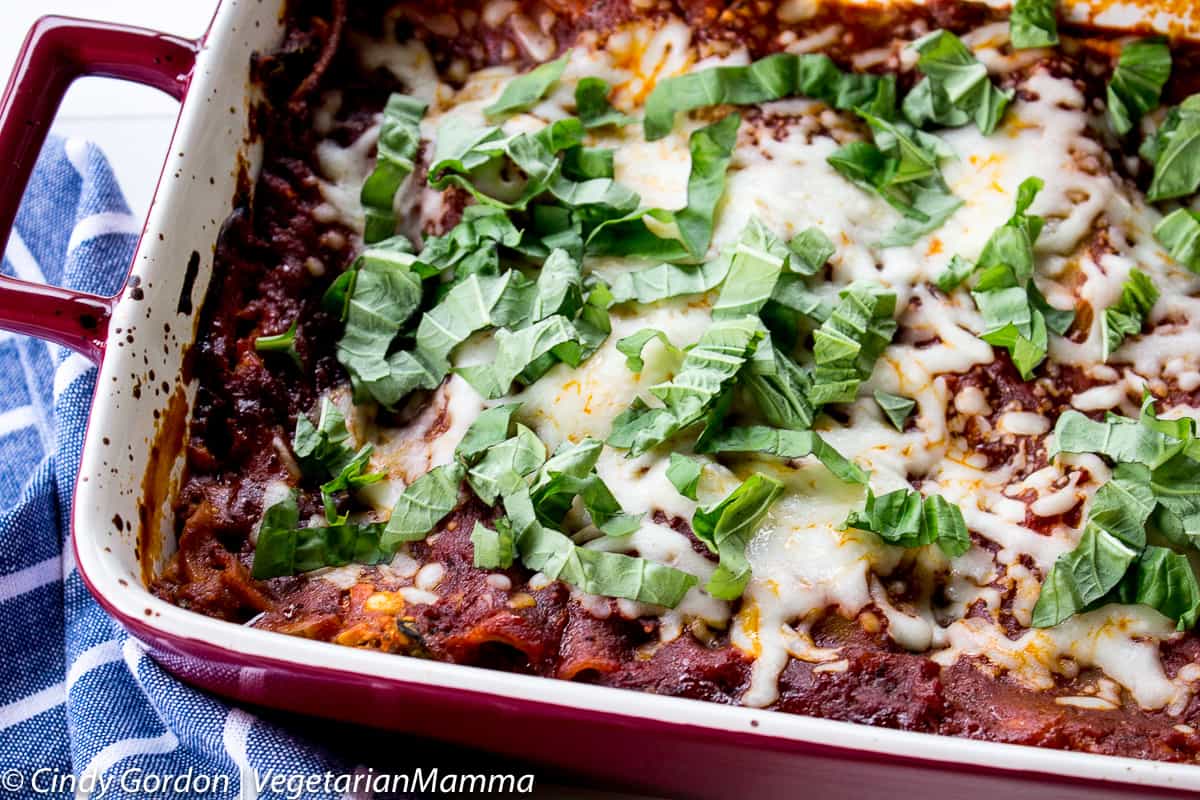 Spinach Mushroom Lasagna topped with fresh basil