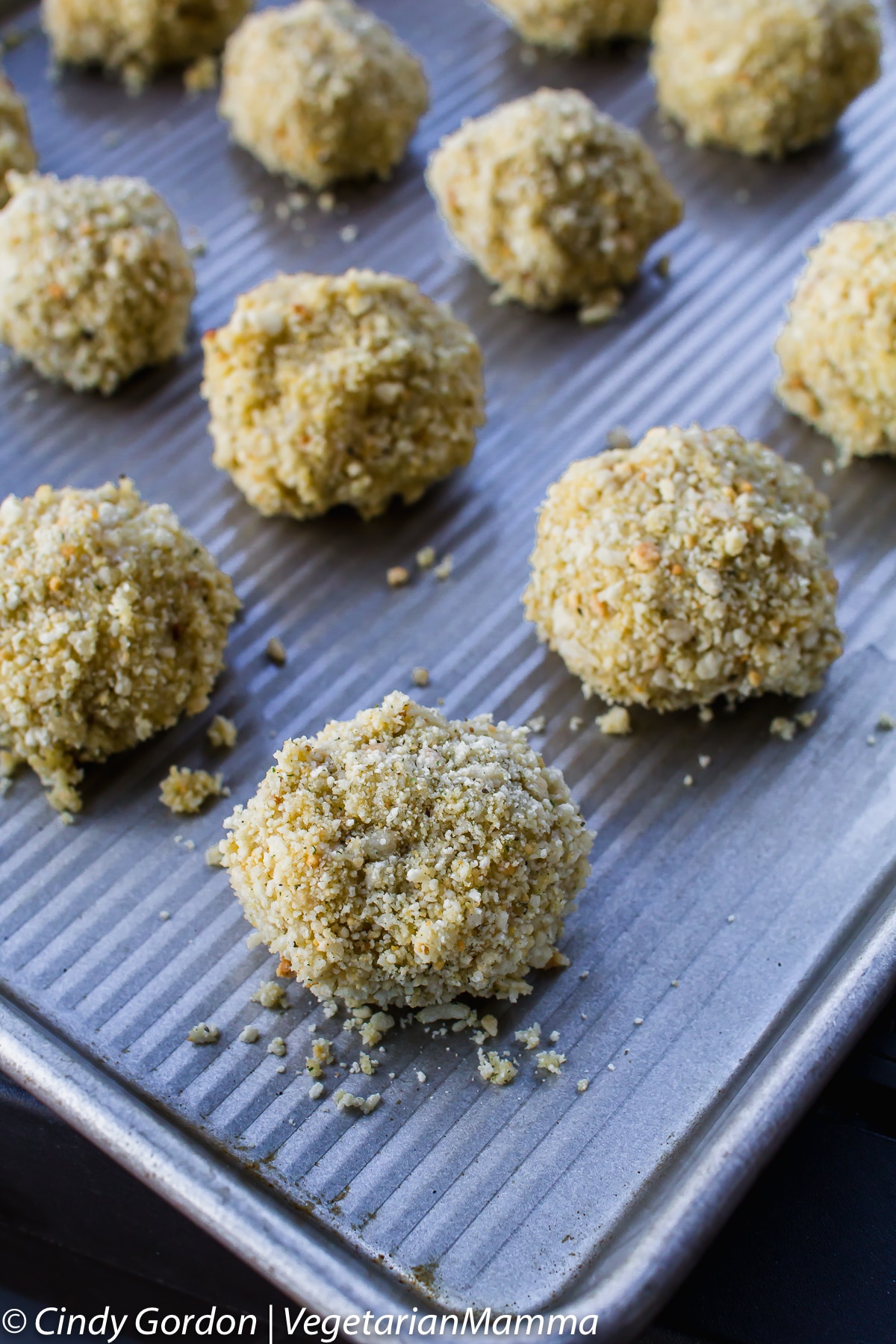 arancini balls breaded with panko, on a metal sheet pan