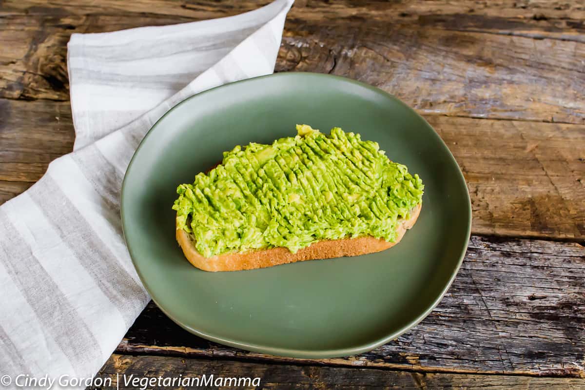 piece of toast with smashed avocado spread on top