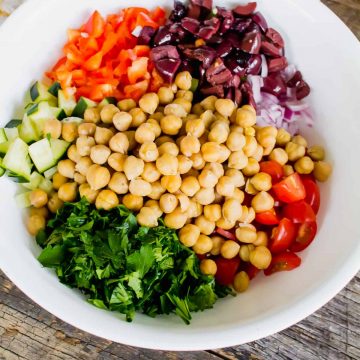 Mediterranean Salad recipe ingredients inside of white bowl