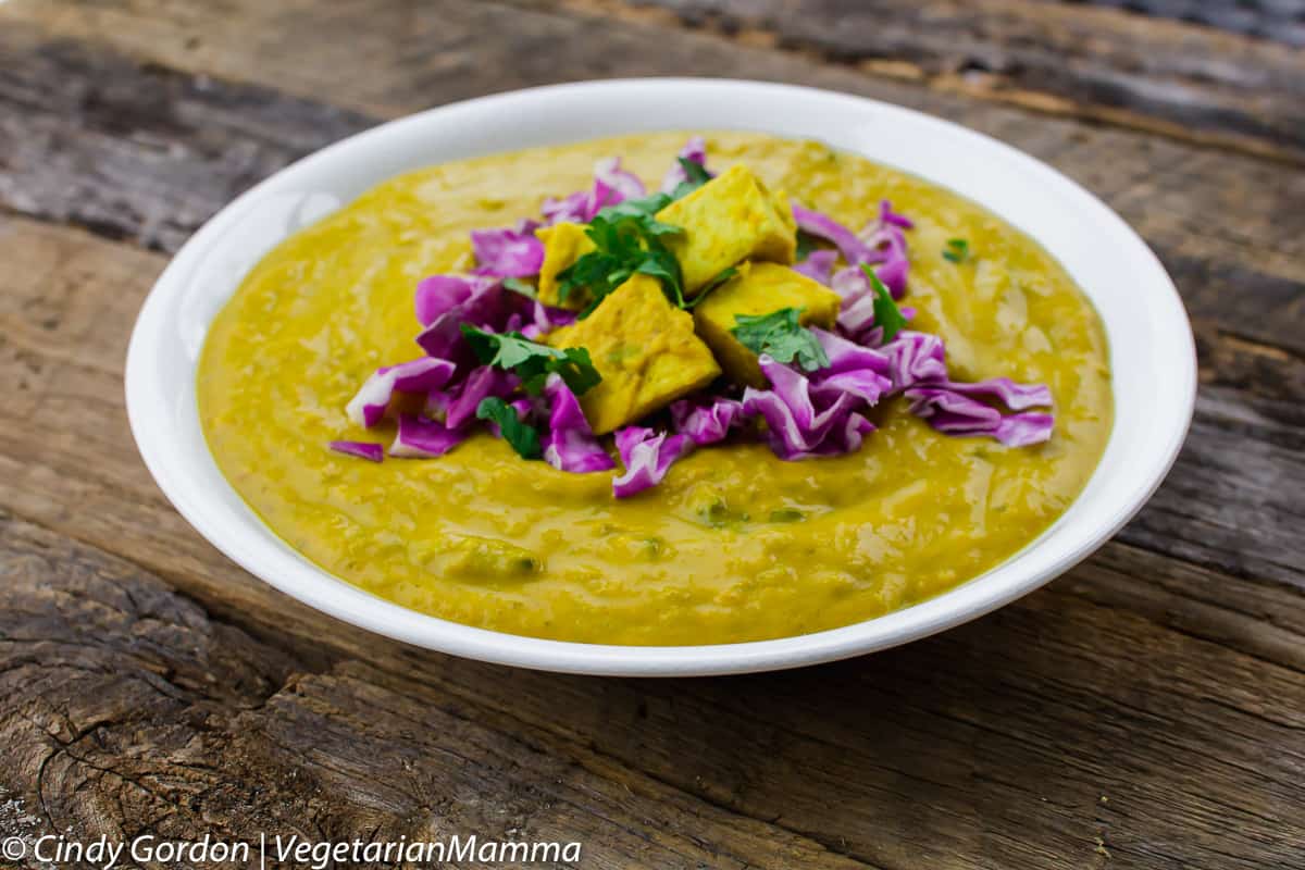 bowl of vegetarian coconut curry soup topped with cabbage and tofu