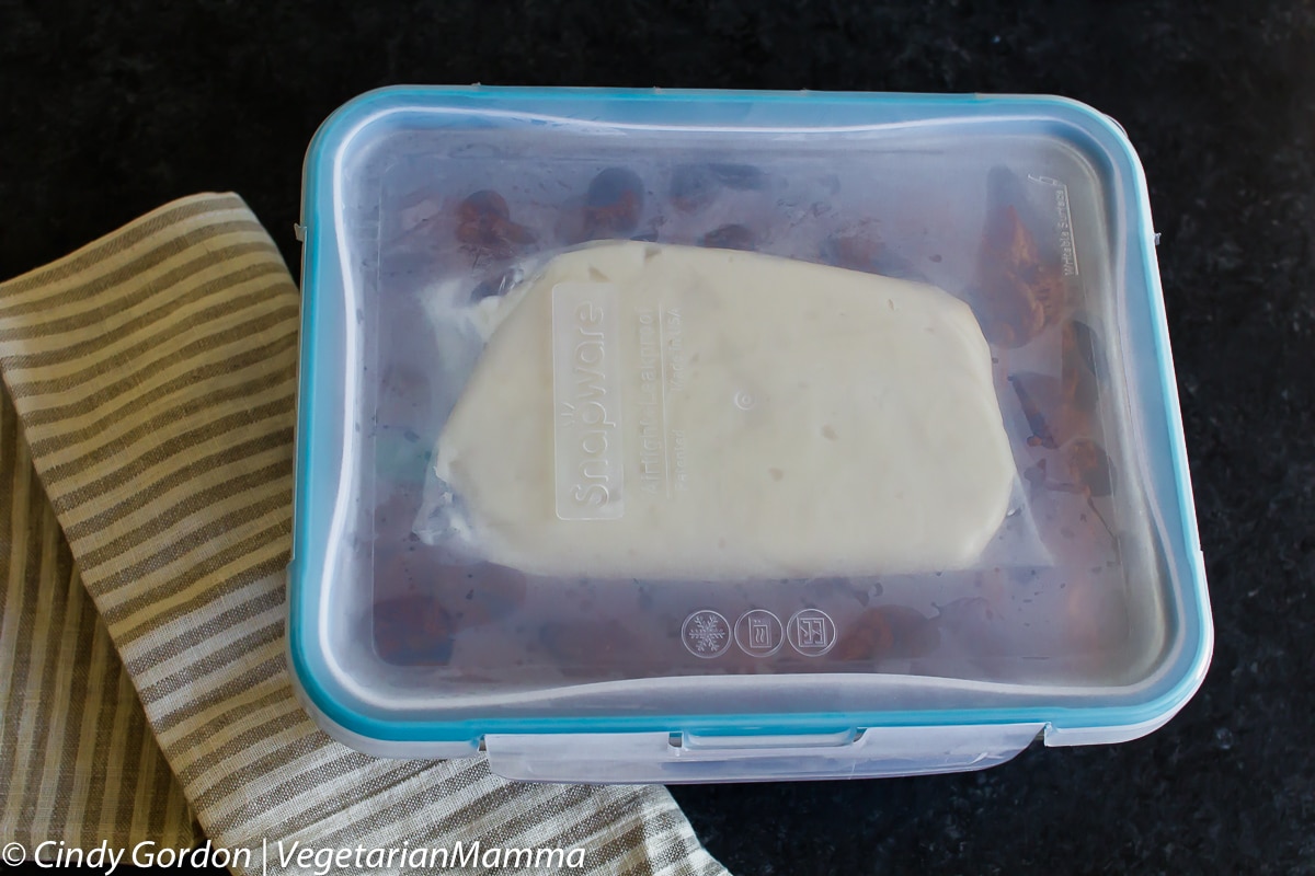 Freezer container full of cinnamon roll french toast casserole.