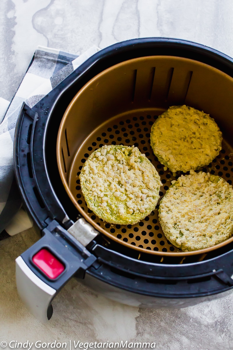 Air Fryer Fried Green Tomatoes in the air fryer basket.