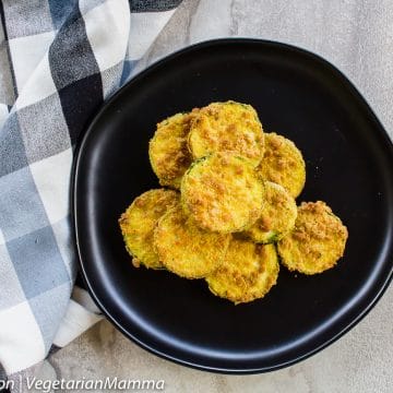 Top down view of Air Fryer Zucchini Coins atop black plate