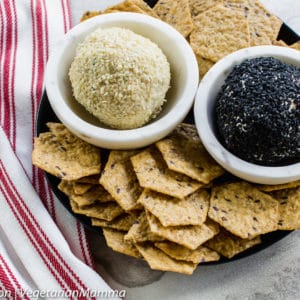 Overhead view of chips and cheese balls atop black plate