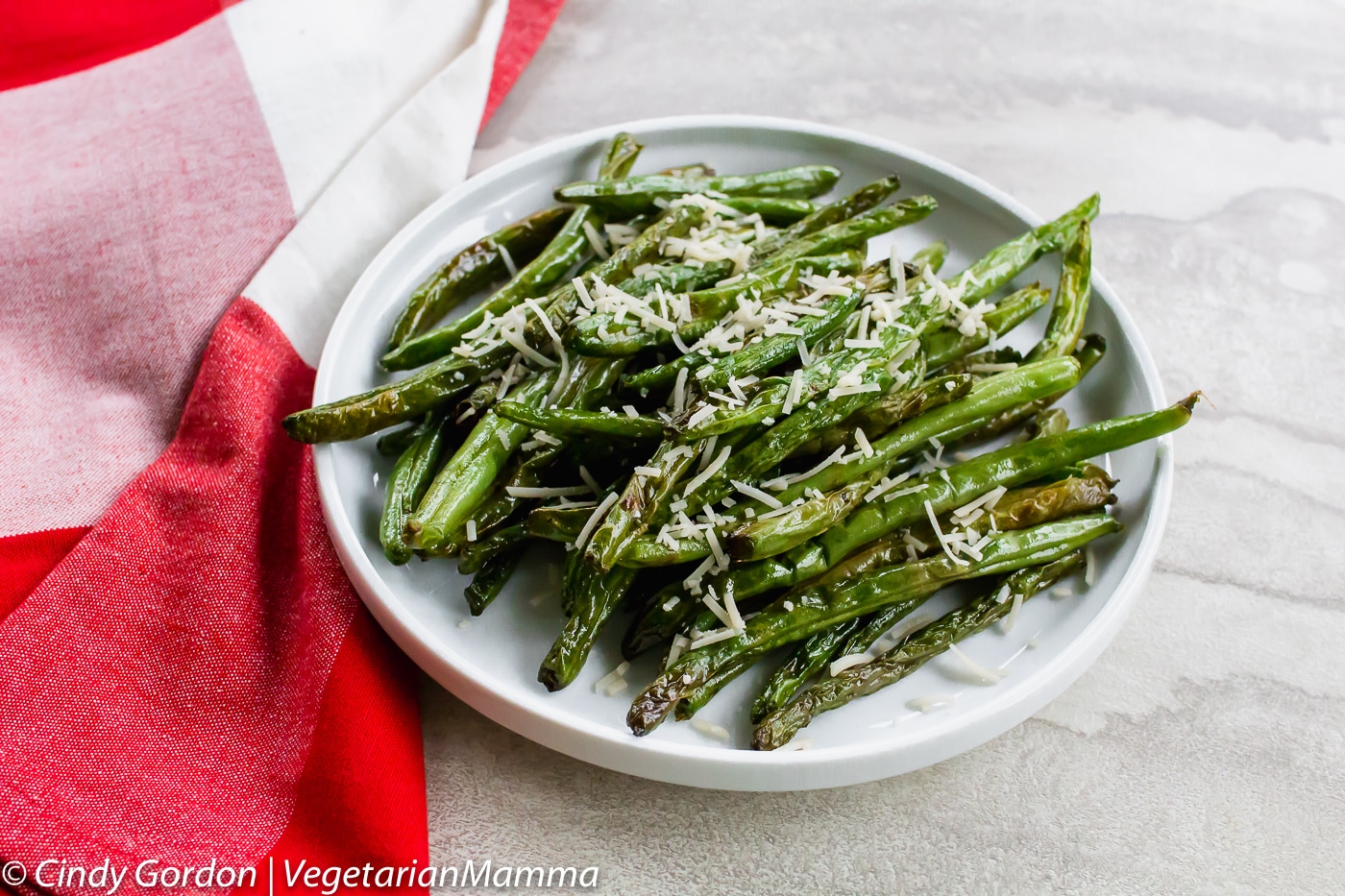 Air Fryer Green Beans can be toped with parmesan cheese.