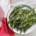 Top down view of Green beans topped with parmesan