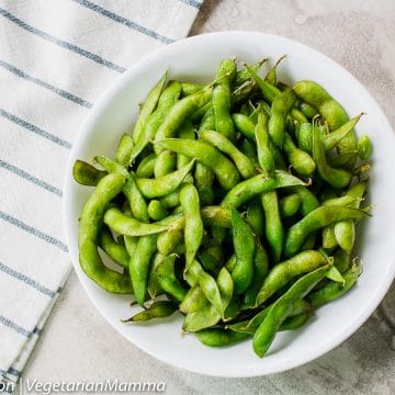 Overhead view of edamame on white and gray table