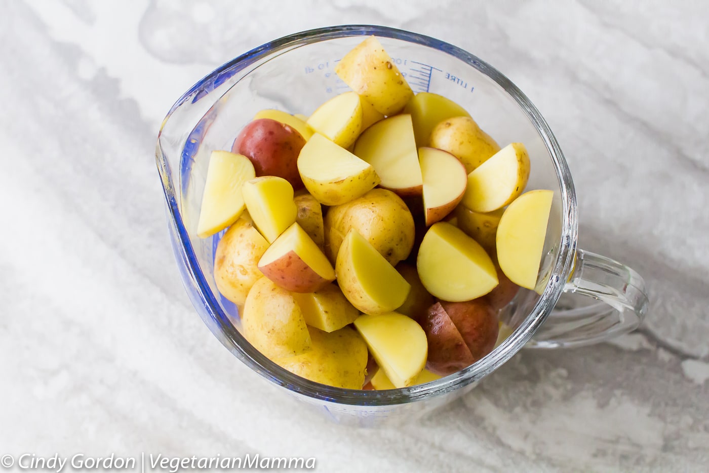 Air Fryer Roasted Potatoes cubed in a measuring cup