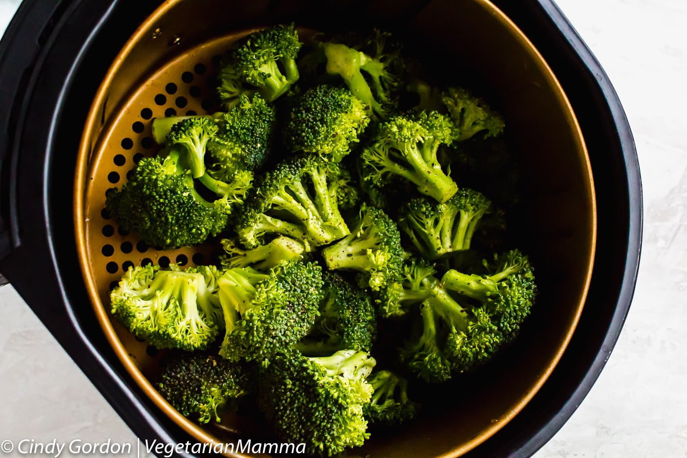 Air Fryer Broccoli - picture of air fryer broccoli in air fryer basket before frying