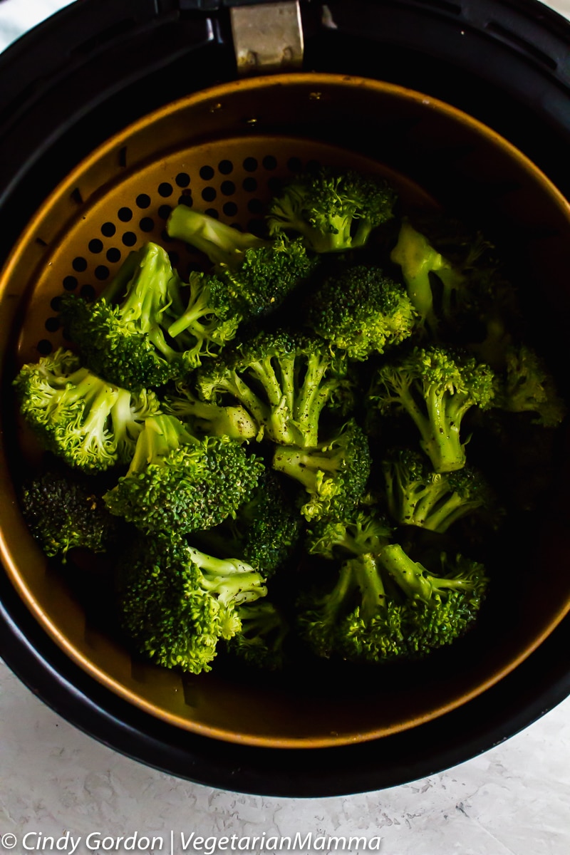 Air Fryer Broccoli - view is of air fried broccoli in the air fryer basket