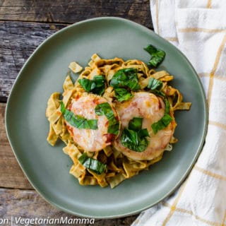 Crispy gluten-free eggplant parmesan served over pasta