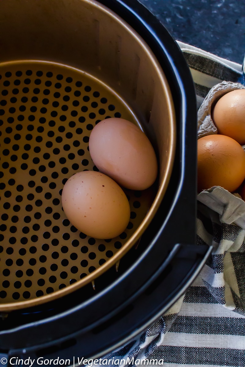 two eggs in an air fryer basket