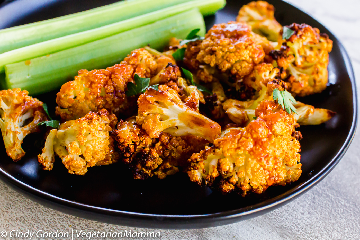 Air Fryer Honey Sriracha Cauliflower ion a plate with cauiflower