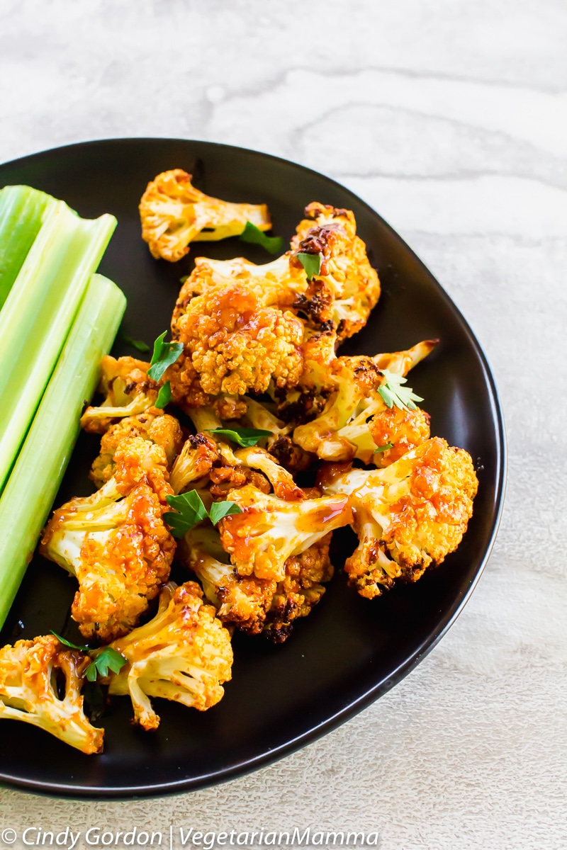 Air Fryer Honey Sriracha Cauliflower on a plate with celery