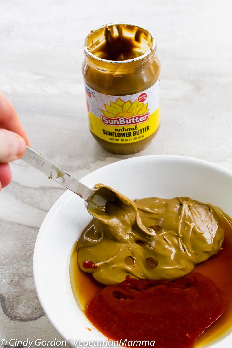 thai lettuce wrap sauce mixture in a bowl and a jar of sunbutter