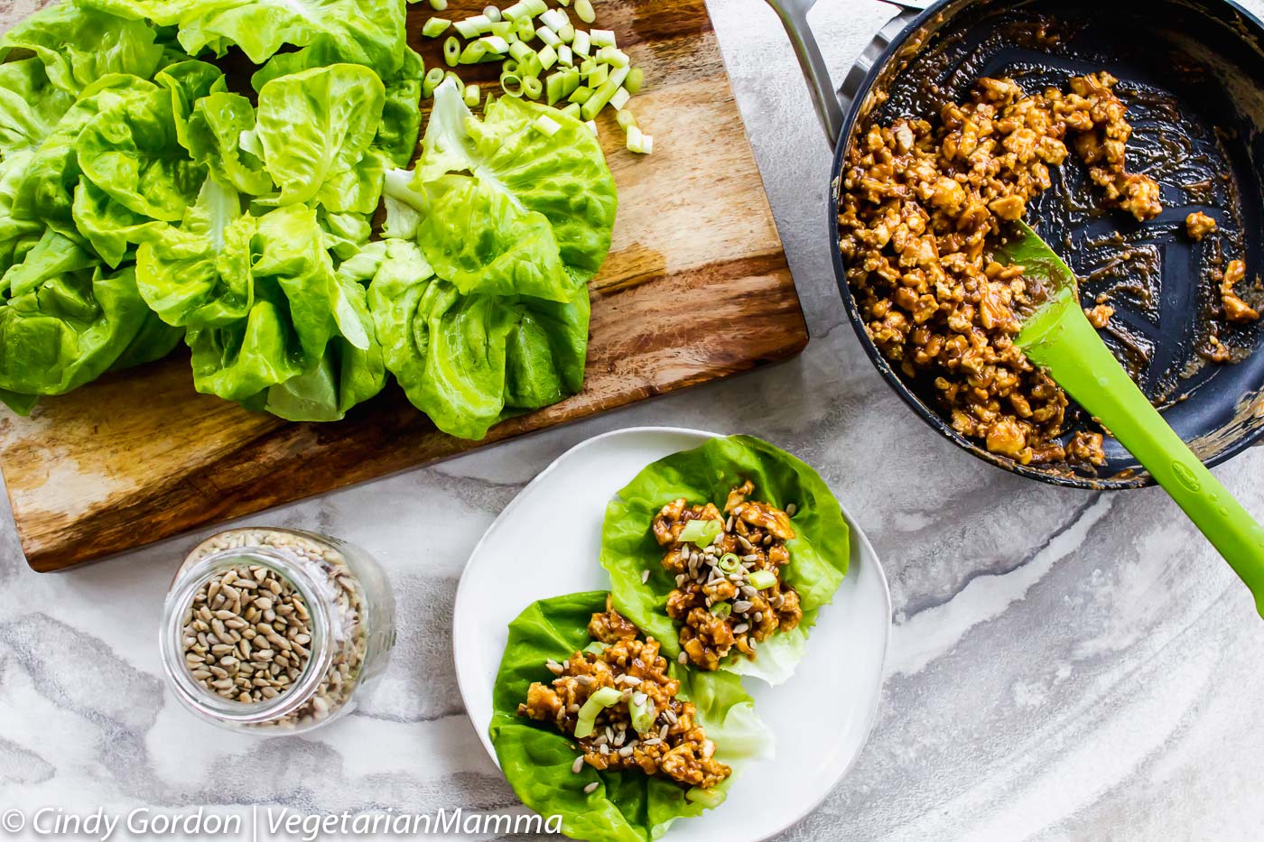 thai lettuce wraps, skilet of mixture and cutting board of ingredients