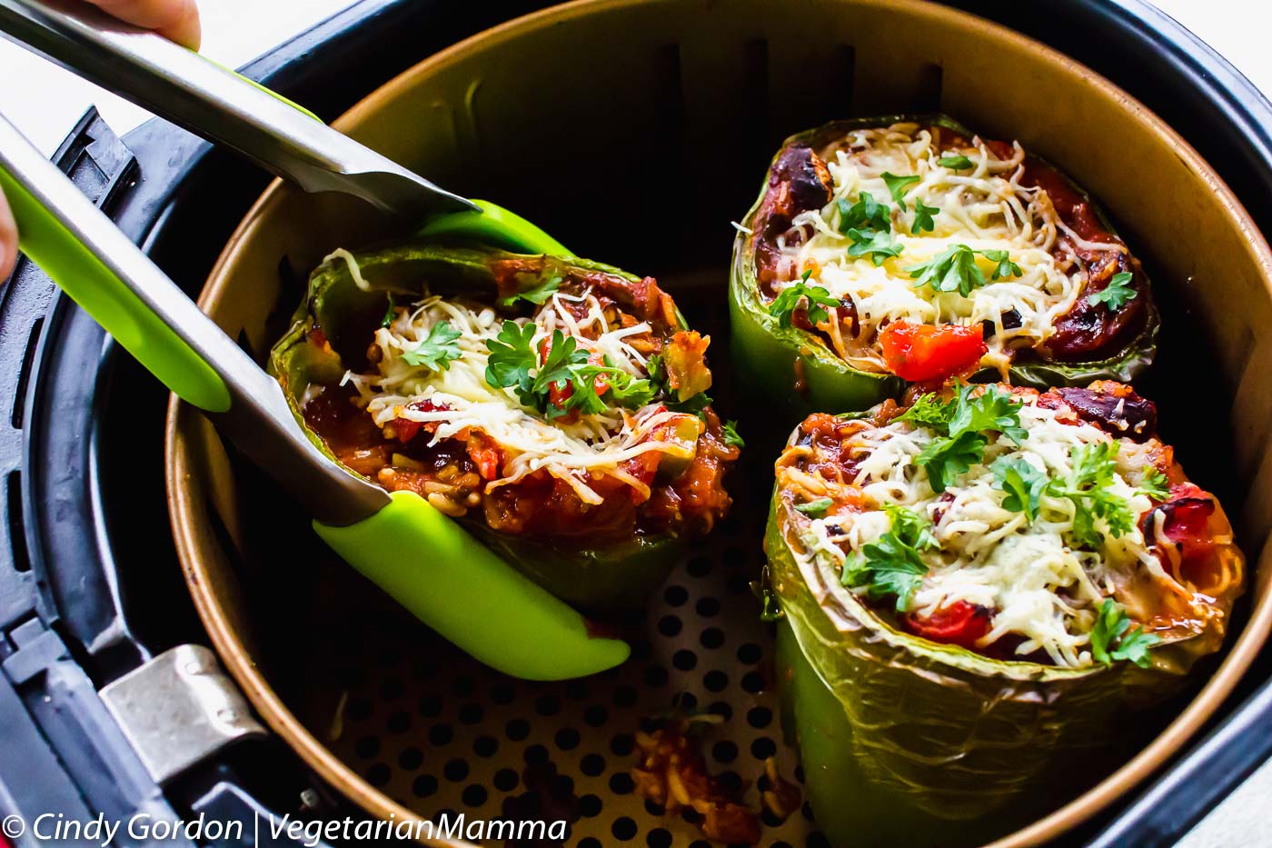 Air Fryer Stuffed Peppers (Vegetarian) with tongs