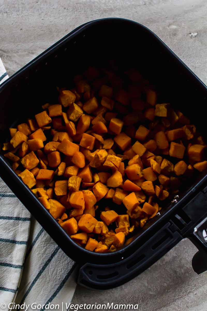cubed sweet potatoes in air fryer basket
