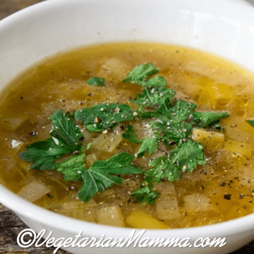 Instant Pot Potato Leek Soup in white bowl atop wooden pallet